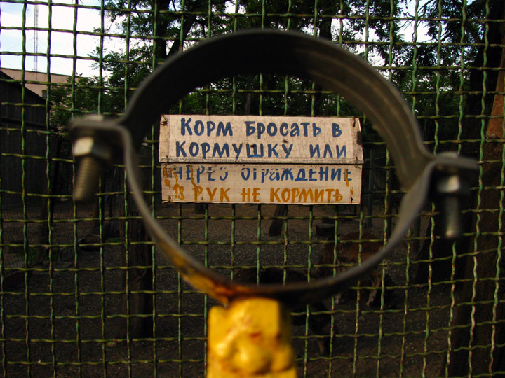 зооуголок в Днепропетровске. Табличка полностью: Корм бросать в кормушку или через ограждение. Из рук не кормить